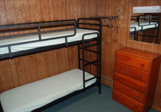 Bunk beds in a rustic lodge.