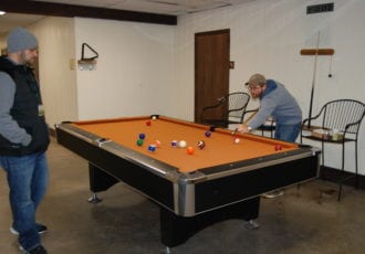 Men playing pool.