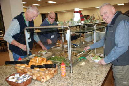 Men at a buffet.