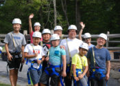 Group of people preparing to go on the high ropes course.