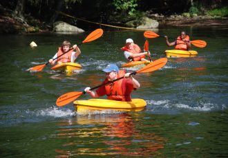 Group kayaking in a river.