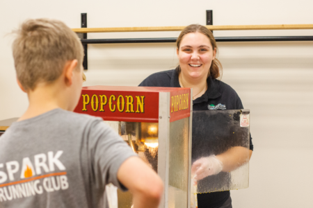 Spruce Lake Retreat worker handing out popcorn