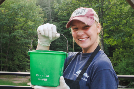 girl holding a bucket during camping ministry